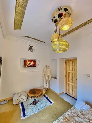 a living room with a table and chandeliers at RIAD dreams dades in Tamellalt