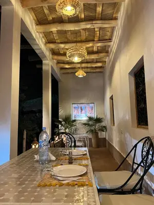 a dining room with a table and chairs at RIAD dreams dades in Tamellalt