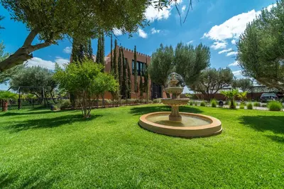 a park with a fountain in the middle of a lawn at Villa Chems - Al Ouidane in Marrakech