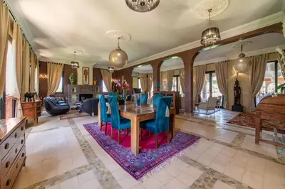a dining room with a table and blue chairs at Villa Chems - Al Ouidane in Marrakech
