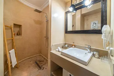 a bathroom with a sink and a mirror at Villa Chems - Al Ouidane in Marrakech