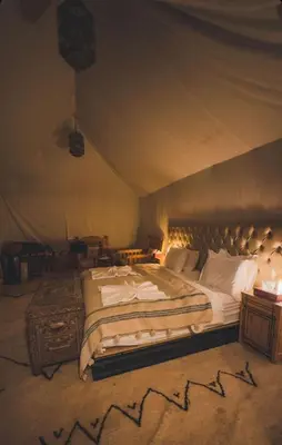 a bedroom with a large bed in a tent at Super Luxury camp in Merzouga
