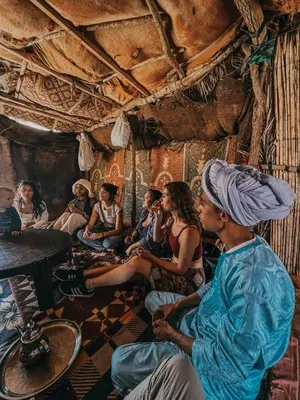 a group of people sitting in a room at Super Luxury camp in Merzouga