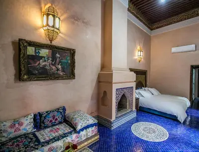 a living room with a couch and a fireplace at Riad Semlalia in Fès
