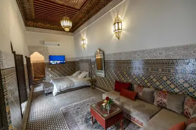 a living room with a couch and a bed at Riad Semlalia in Fès