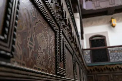 a close up of a wooden door with a window at Riad Semlalia in Fès