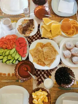 a table with many plates of food on it at Merzouga Top Luxury Camp in Merzouga