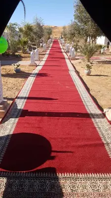 a red carpeted walkway in a cemetery at Luxury Camp Rachid in Merzouga