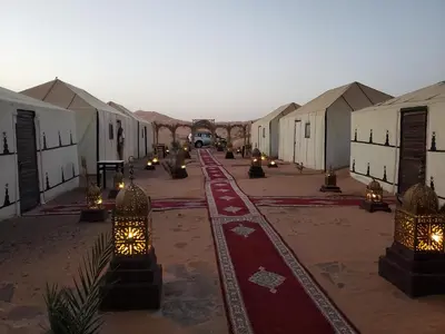 a group of buildings with lights in a street at Luxury Camp Rachid in Merzouga
