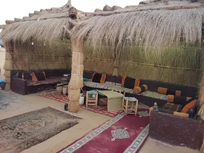 a living room with a couch in a hut at Luxury Camp Rachid in Merzouga