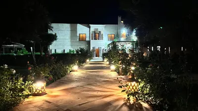 a pathway leading to a house at night with lights at Villa Malaa'ika in Marrakech