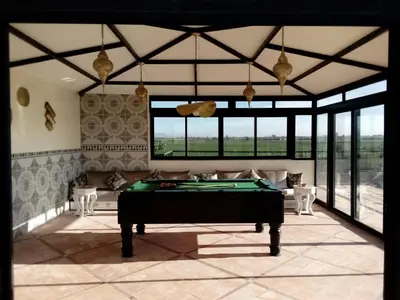 a living room with a pool table in it at Villa Malaa'ika in Marrakech