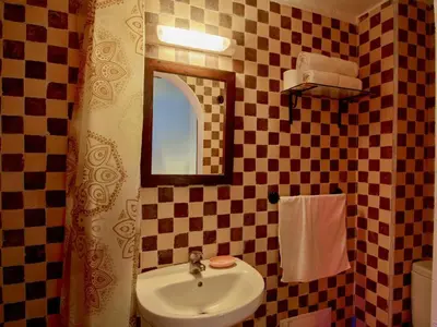 a bathroom with a sink and a mirror at Bejaad in Boujad