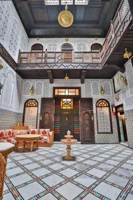 a living room with a large room with a table and a couch at Riad Farouzi Fes in Fès
