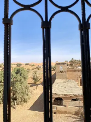 a view from a window of a building in the desert at Boka Dunes Houses Merzouga in Merzouga