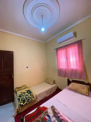 a bedroom with two beds and a ceiling with a window at Boka Dunes Houses Merzouga in Merzouga