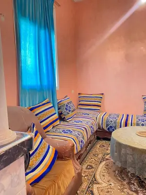 two beds in a room with a window at Boka Dunes Houses Merzouga in Merzouga
