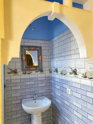 a bathroom with a white sink and a mirror at Boka Dunes Houses Merzouga in Merzouga