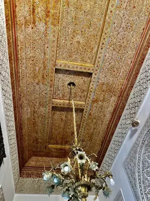 a chandelier hanging from a ceiling in a room at Riad Damia Suite & Spa in Fès