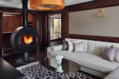 a living room with a couch and a fireplace at Fes Marriott Hotel Jnan Palace in Fès