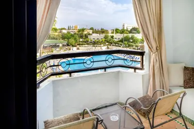 a balcony with a view of a swimming pool at Fes Marriott Hotel Jnan Palace in Fès