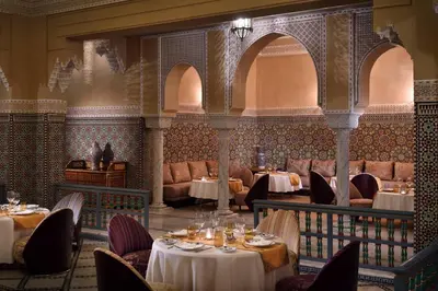 a restaurant with tables and chairs in a room at Fes Marriott Hotel Jnan Palace in Fès