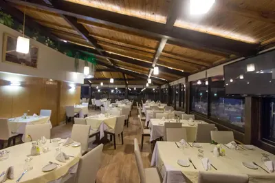 a dining room with white tables and chairs at Zahrat Al Jabal in Fès