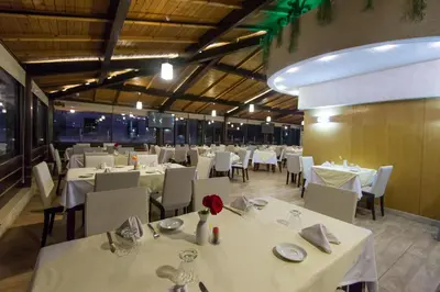 a dining room with white tables and white chairs at Zahrat Al Jabal in Fès