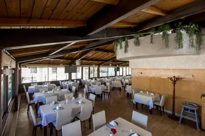 a dining room with white tables and chairs at Zahrat Al Jabal in Fès