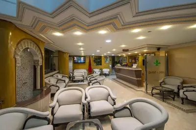 a waiting room with white chairs and a salon at Zahrat Al Jabal in Fès