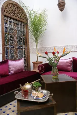 a living room with a couch and a table at Riad Attarine in Fès