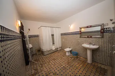 a bathroom with a sink and a toilet and a mirror at Riad Sara in Fès
