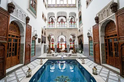 an indoor pool in a building with arches at Riad Arabesque & Spa in Fès