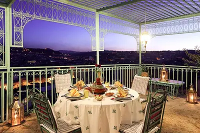 a table with food on top of a balcony at Riad Arabesque & Spa in Fès