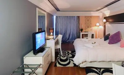 a hotel room with two beds and a flat screen tv at Royal Mirage Fes Hotel in Fès