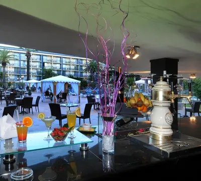 a table with a vase with flowers on it at Royal Mirage Fes Hotel in Fès