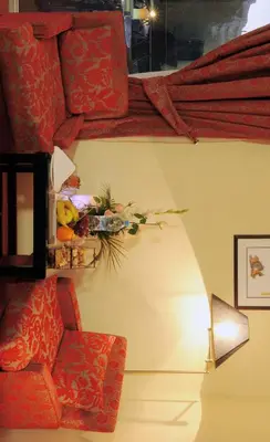 a living room with a chair and a lamp at Royal Mirage Fes Hotel in Fès