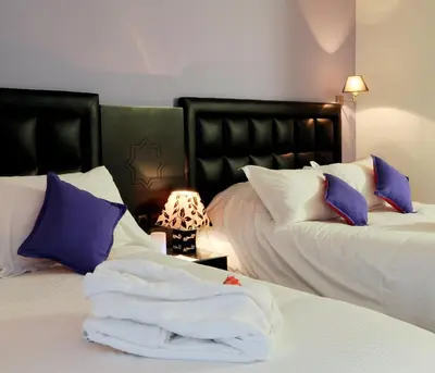 a room with two beds with towels on them at Royal Mirage Fes Hotel in Fès