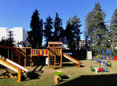 a playground with a bunch of play equipment in the grass at Royal Mirage Fes Hotel in Fès