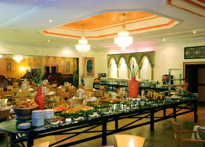 a buffet line with many plates of food in a restaurant at Royal Mirage Fes Hotel in Fès