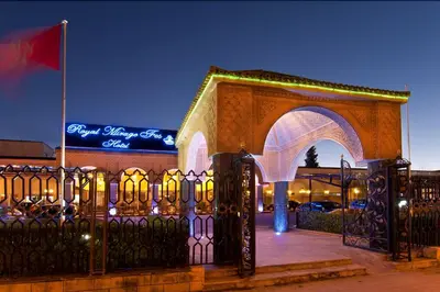 a gate to a building with a flag and a sign at Royal Mirage Fes Hotel in Fès