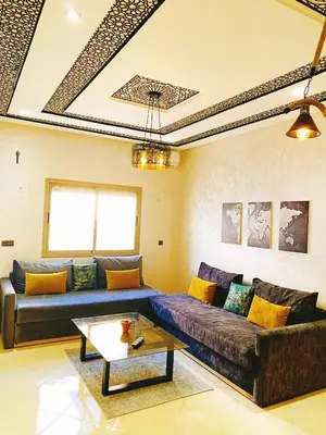 a living room with a couch and a table at Appartement calme à Fès in Fès