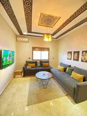 a living room with a couch and a table at Appartement calme à Fès in Fès