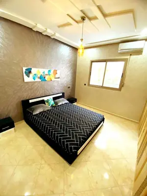 a bedroom with a large bed in a room at Appartement calme à Fès in Fès