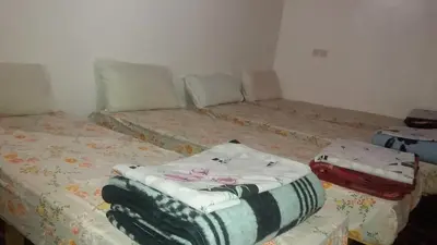 two twin beds in a room at Gîte Assafar in Kalaat MGouna