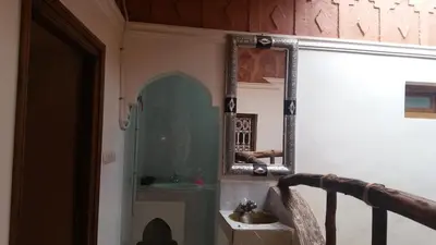 a bathroom with a mirror and a sink at Gîte Assafar in Kalaat MGouna