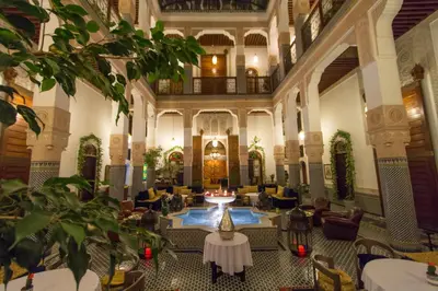 a lobby of a hotel with tables and chairs at Riad Myra in Fès