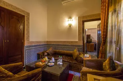 a living room with a couch and a table at Riad Myra in Fès