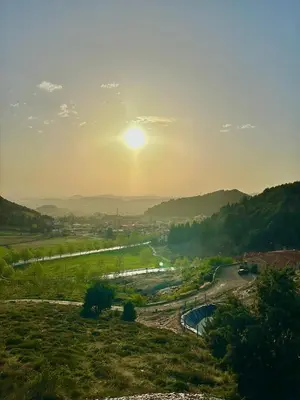 a view of a river with the sun in the sky at ATGAL Ferme D'hote in Azrou