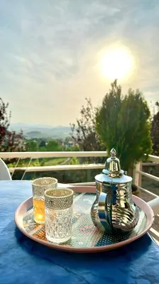 a tray with a tea pot and two glasses on a table at ATGAL Ferme D'hote in Azrou